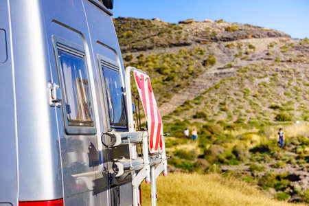 Caravan recreational vehicle with rack on back and rear warning striped sign white and red for...
