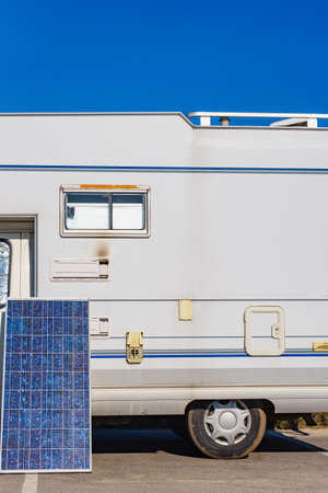 Solar photovoltaic panel, charging battery at camper car rv. Electricity in motorhome trip. Camping...