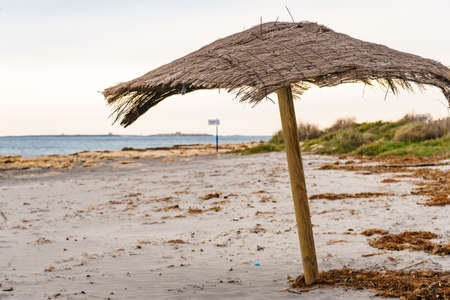 Shelter on sand beach. Cloudy weather. Travel holidays concept.の写真素材