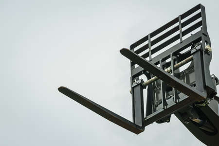 Forklift industrial loader or stacker against sky. Part of agricultural machine. Telescopic handler.