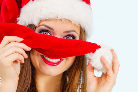 Happy woman wearing santa claus red hat having fun. Christmas holiday season.の写真素材