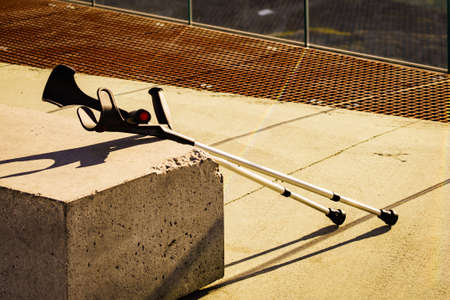Crutches outdoor on bench. Accident broken leg in travel.の写真素材