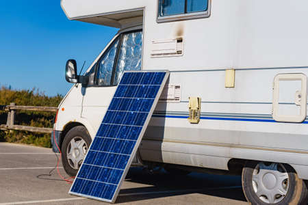 Solar photovoltaic panel, charging battery at camper car rv. Electricity in motorhome trip. Camping equipmentの写真素材