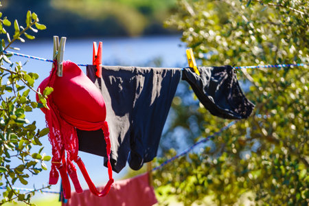 Clothes hanging to dry on laundry line outdoors. Camping on holidays tripの写真素材