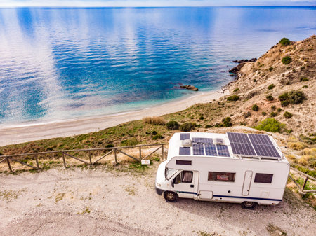 Caravan with solar panels on roof camping on cliff sea coast. Mediterranean region of Nerja, Costa del Sol in Andalusia, Spain.の写真素材