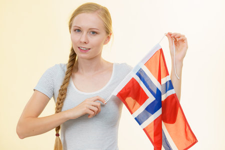 Blonde girl braid hair with norwegian flag. Scandinavian people.の写真素材