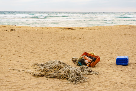 Sandy beach with old fishing rope net and tackle.の写真素材