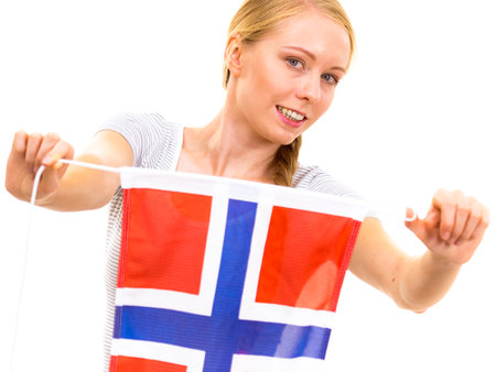 Blonde teenage girl holding flag of Norway. education. Norwegian language school. Visit Norway concept.の写真素材