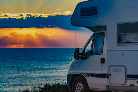 Camper rv camping on seacoast nature in the morning at sunrise. Holidays in Spain, travel with motor home.の写真素材