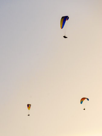 Paragliding. Extreme sports. Paraglider silhouette flying in the sky.