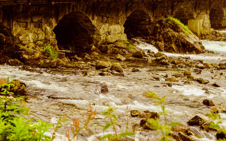 detail view. Stone bridge arch and water. Road crossing river, Latefoss Norway.の写真素材