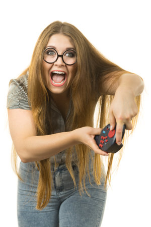 Young adult woman playing on the video console holding game pad. Gaming gamers concept.の写真素材
