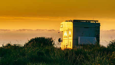 Camper rv camping on coast nature in the morning at sunrise. Holidays in Spain, travel with motor home.の写真素材