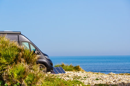 Campervan rv camping on sea shore in Spain. Van life, mobile home holidays.の写真素材