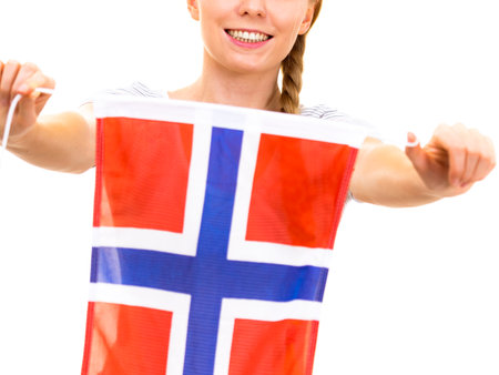 Blonde teenage girl holding flag of Norway. education. Norwegian language school. Visit Norway concept.の写真素材
