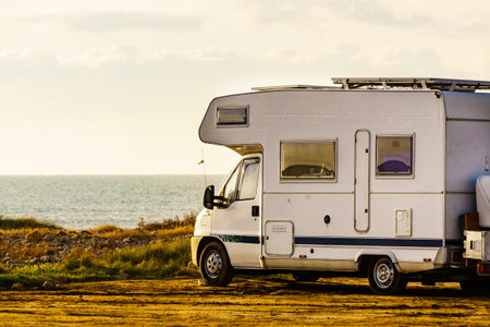 Camper vehicle camping on nature seacoast. Adventure, tour with mobile home.の写真素材
