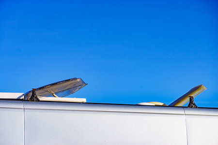 Sunroof, raisable panel window on roof top of rv camper vehicle against blue sky. Traveling by motor home.の写真素材
