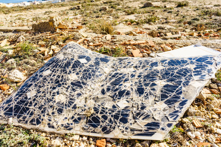Broken destroyed cracked solar photovoltaic panel, charging batteries.の写真素材
