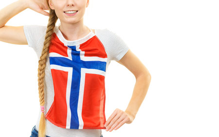 Blonde female student holding Norwegian flag on her chest. Travel and education. Learning foreign languages.の写真素材