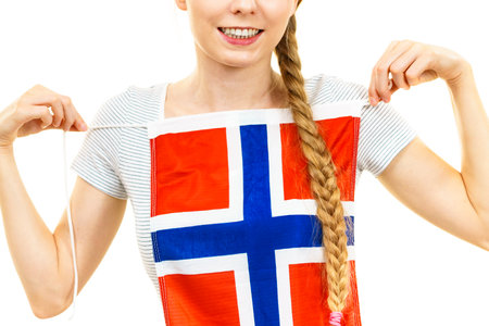 Blonde student woman holding Norwegian flag on her chest. Education, language learning.の写真素材