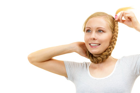 Blonde girl with long braid hair around the neck. Haircare, hairstyling.の写真素材