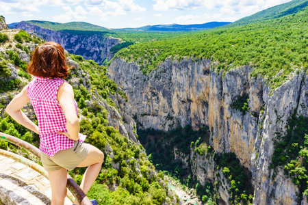 Tourist woman enjoying mountain view landscape. Verdon Gorge in French Alps, Provence France. River grand canyon.の写真素材