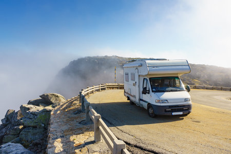 Caravan on mountain road. Serra da Estrela in Portugal. Adventure and holidays with mobile home.の写真素材