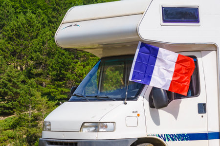 Caravan with french flag camping on green nature. Motor home vacation in France.の写真素材