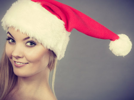 Xmas, seasonal clothing, winter christmas concept. Happy woman wearing Santa Claus helper hatの写真素材