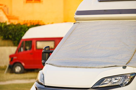 Camper with external thermal screen blind at window pane, front windscreen of the car. Camping on nature. Holidays and travel in motor home.の写真素材