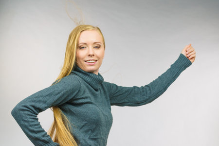 Smiling girl with blowing long blonde hairの写真素材