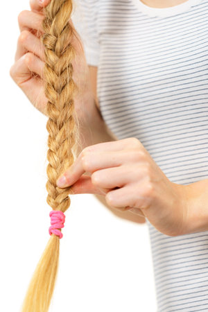 Unrecognizable female with blonde long braid hair. Haircare, hairstyling, feminine style.の写真素材