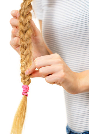 Unrecognizable female with blonde long braid hair. Haircare, hairstyling, feminine style.の写真素材