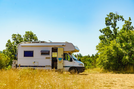 Caravan rv on nature. Motor home camping car in summer landscape. Adventure with camper vehicle..の写真素材