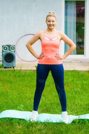 Woman doing exercises gym outdoors in garden. Workout sport and training. Staying fit and healthy.の写真素材