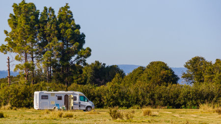 Caravan recreational vehicle on mediterranean coast in Spain. Camping on nature. Vacation and traveling in mobile home.の写真素材