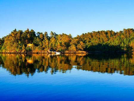 Norwegian fjord landscape near Bergen. Water shore in sunset light. Nature.の写真素材