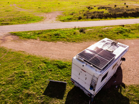 Aerial view of camper with many solar photovoltaic panels on roof camping on nature in Portugal. Renewable free energy. Caravan holidays.の写真素材