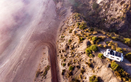 aerial view. Caravan with solar photovoltaic panels on roof camping on cliff sea shore. Mediterranean region of Villaricos, Almeria, eastern Andalusia, Spain.の写真素材