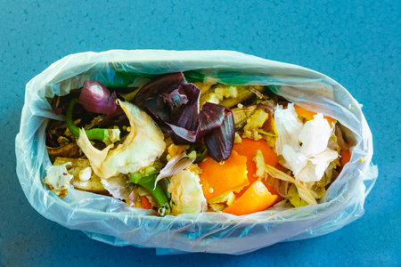 Vegetable peels scraps in bowl. Compost concept, recycling of food waste.の写真素材
