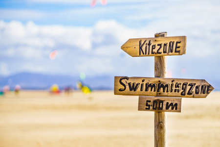 Kitezone and swimmingzone board sign at beach in Tarifa Spain. Kiteboarding. Sports activities.の写真素材