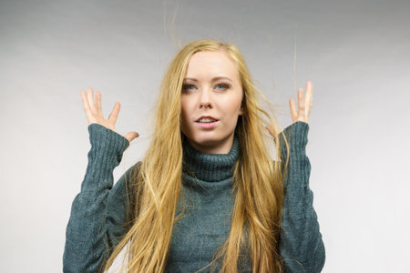 Girl long blonde hair with surprised face expression.の写真素材