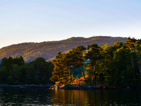 Norwegian fjord landscape near Bergen. Water shore in sunset light. Nature.の写真素材