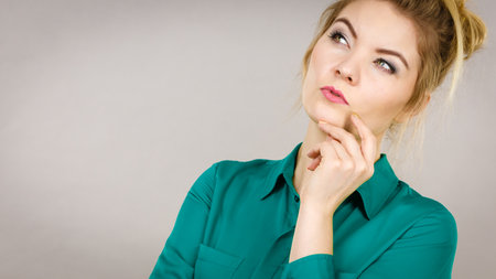 Young business woman wearing jacket intensive thinking finding great problem solution and ideas.の写真素材