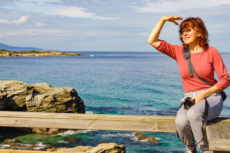 Tourist woman enjoying sea coast landscape, visiting Cathedral Beach in Galicia Spain. Playa de las Catedrales, As Catedrais in Ribadeo, province of Lugo.の写真素材