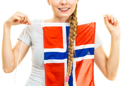 Blonde young woman teen girl braid hair holds norwegian flag. Scandinavian people.の写真素材