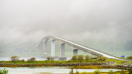 BGimsoystraumen bridge over fjord on Lofoten islands. Summer time, foggy hazy day, overcast weather.の写真素材