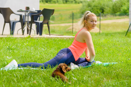 Woman doing exercises gym outdoors in garden. Workout sport and training. Staying fit and healthy.の写真素材