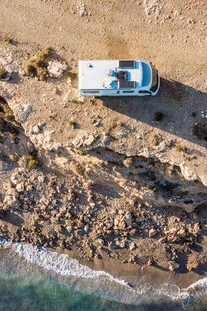 Caravan with solar panels on roof camp on coastal high cliff. Mediterranean sea in Spain. Motor home holidays trip.の写真素材