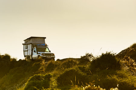 Off road 4x4 car equipped with camping gear roof tent camping on natureの写真素材